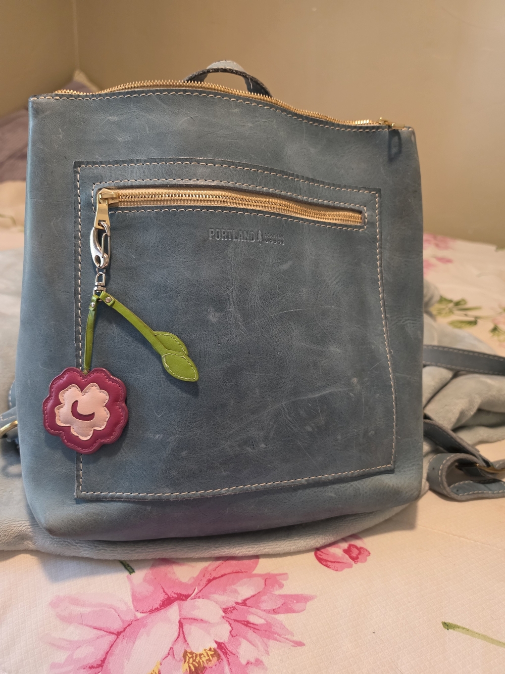Portland Leather Goods Blue Backpack with Pink Flower Charm